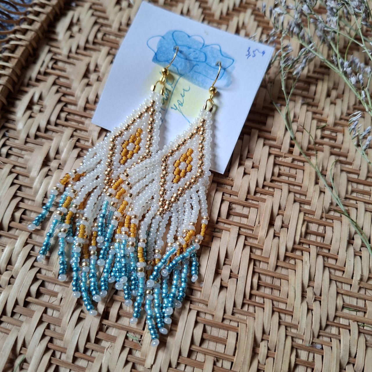 Statement fringe earrings with geometric bead pattern