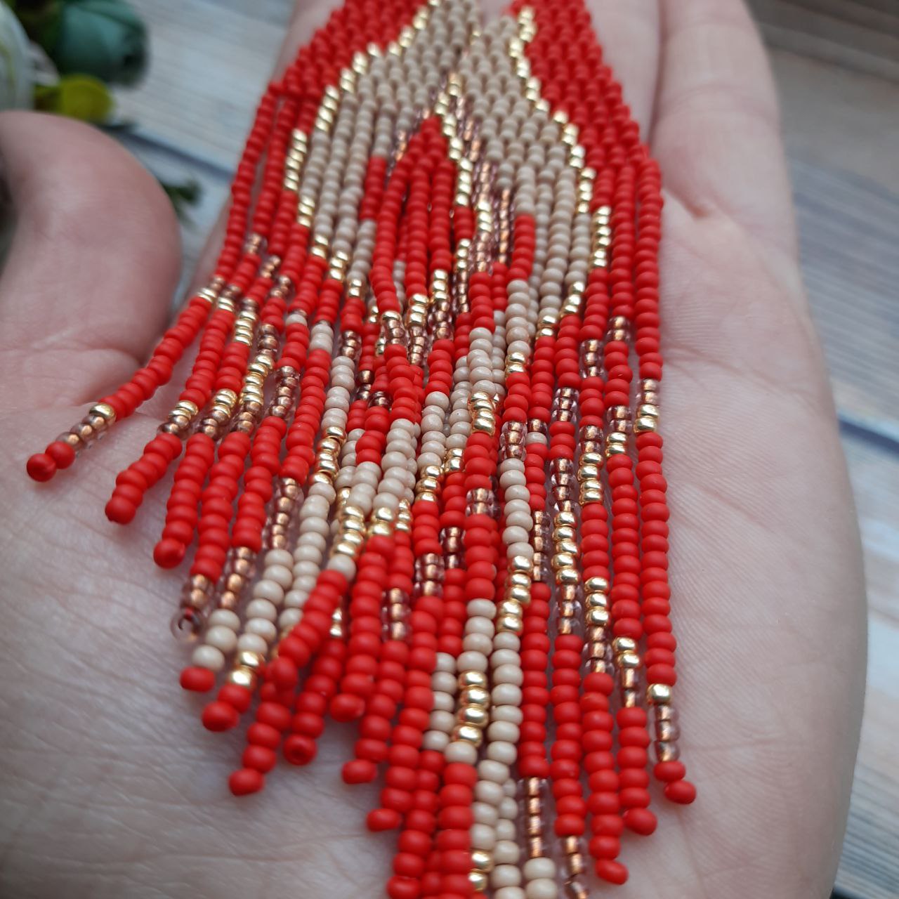 Boho style handmade earrings with vibrant red seed beads.