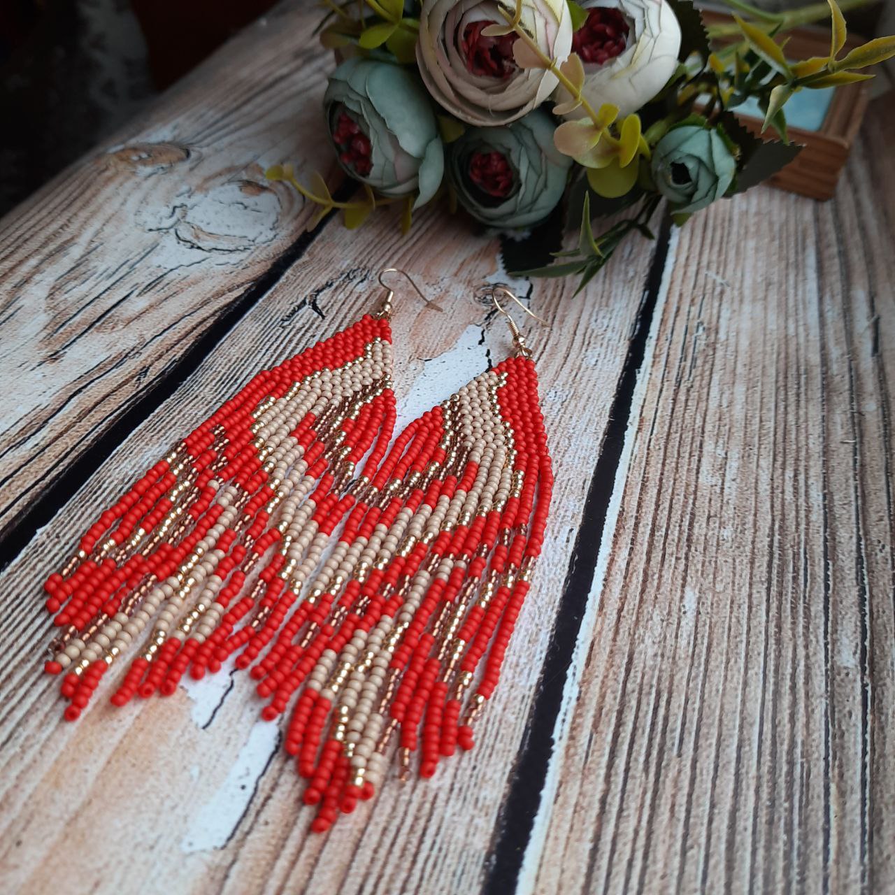 Long red fringe earrings with delicate handmade bead design.
