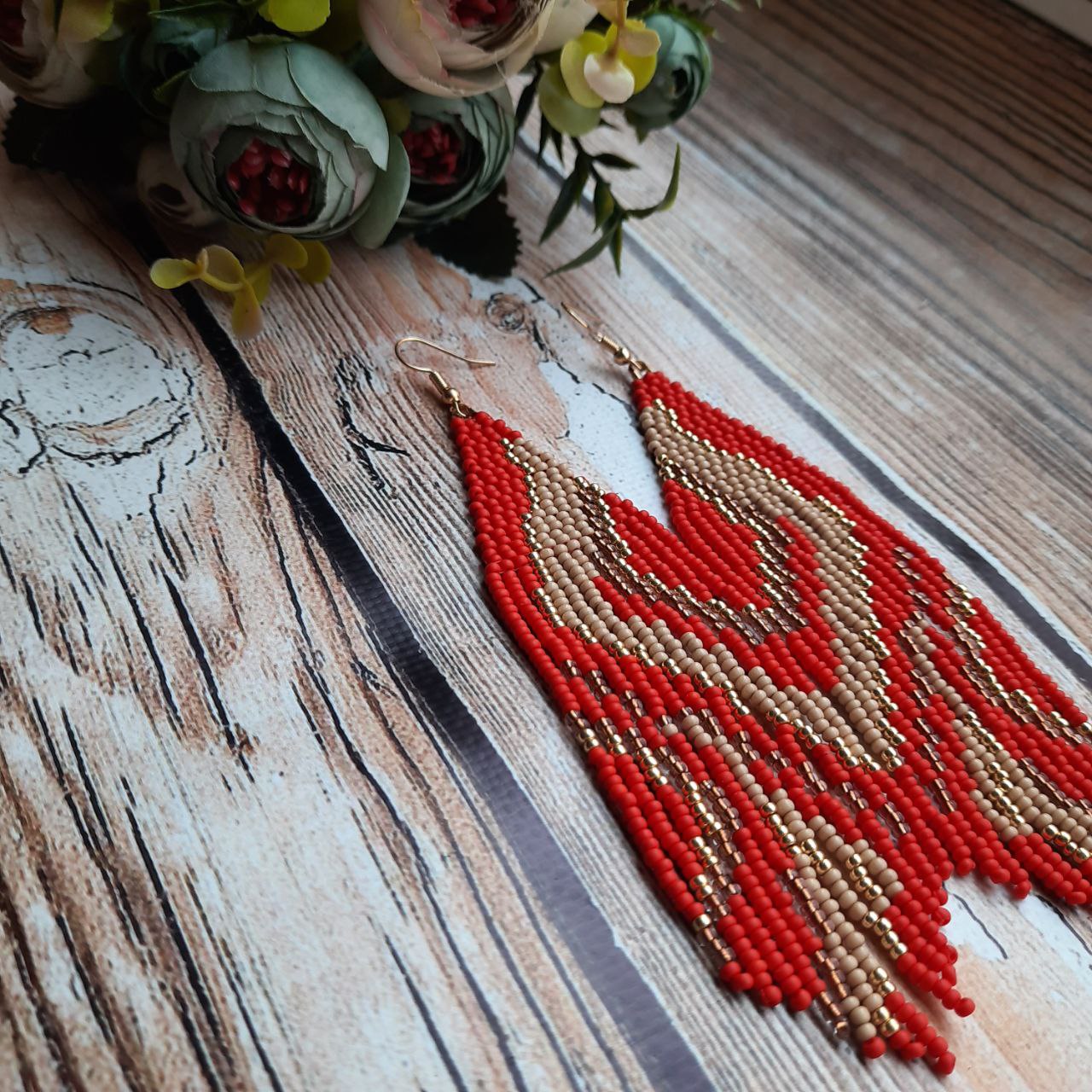 Close-up of detailed beadwork on handmade fringe earrings.