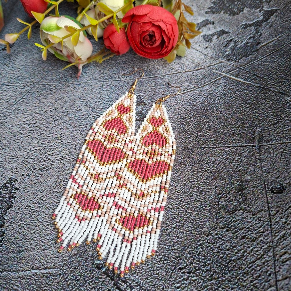 Close-up view showing the delicate beadwork and soft pink tones.