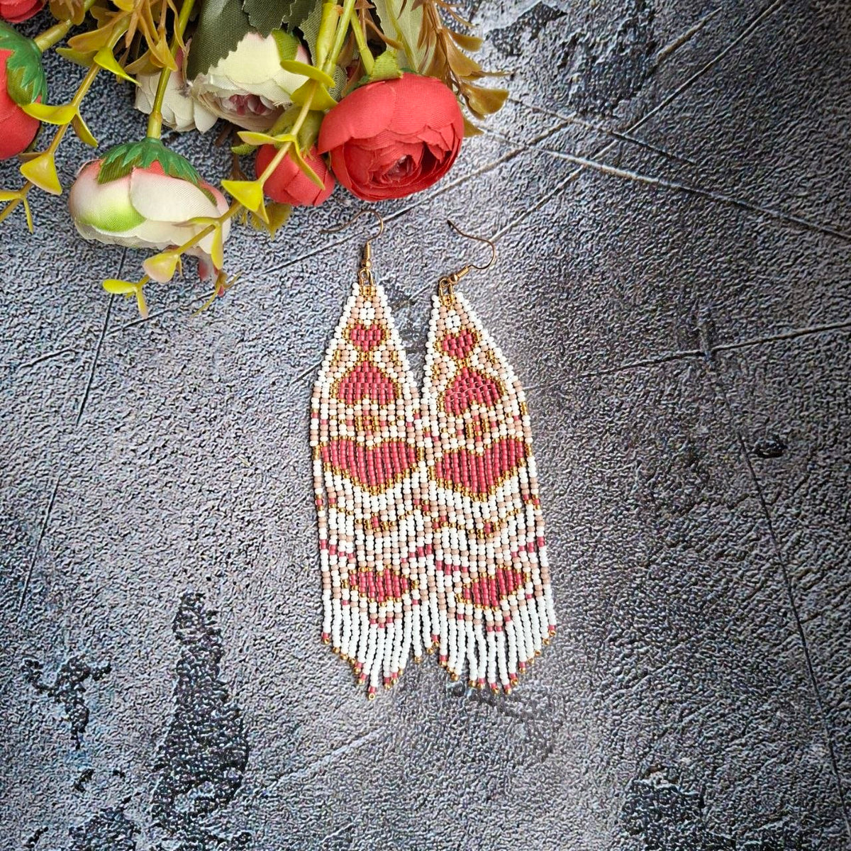 Full view of the earrings highlighting their elegant long fringe design.