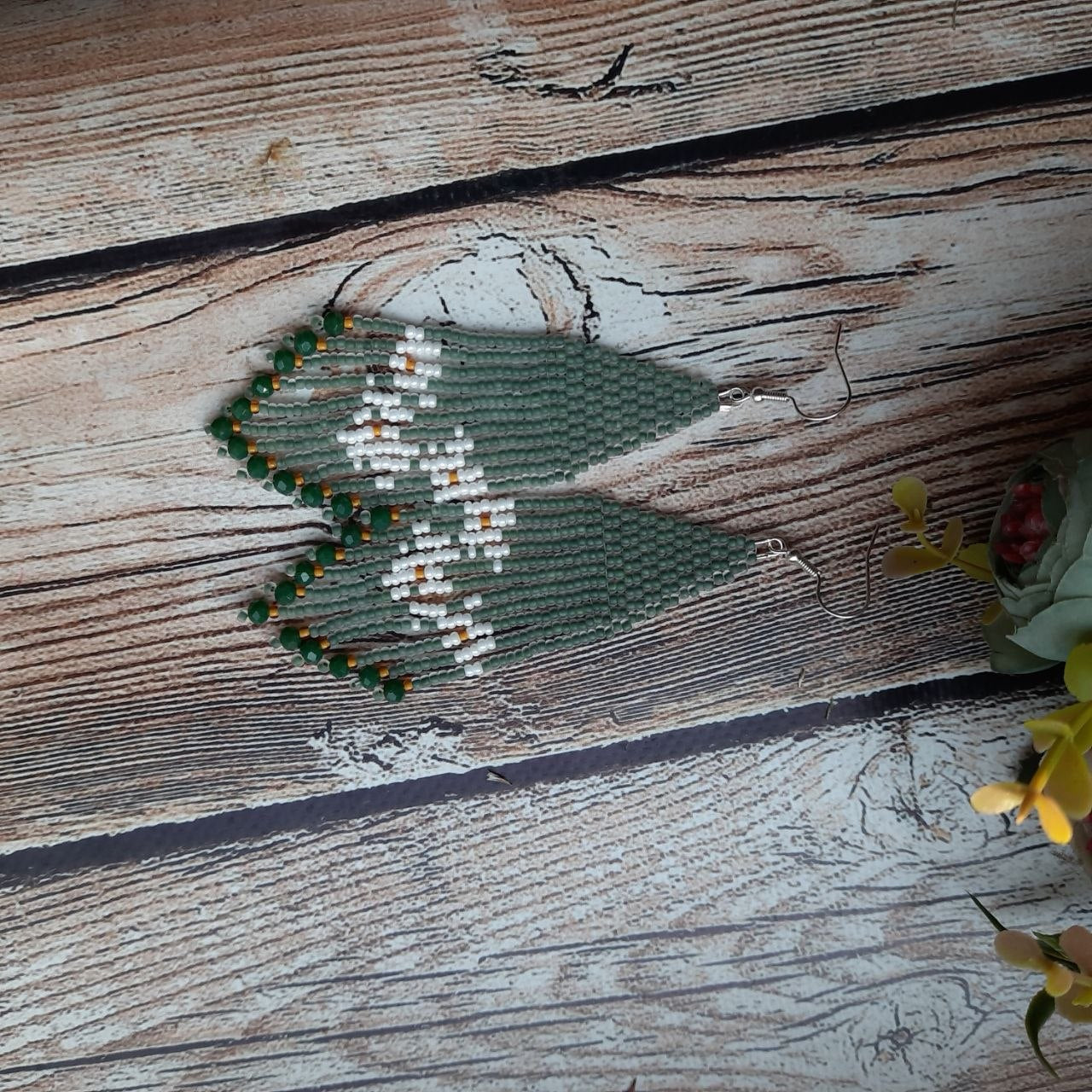 Green beaded daisy earrings in boho style