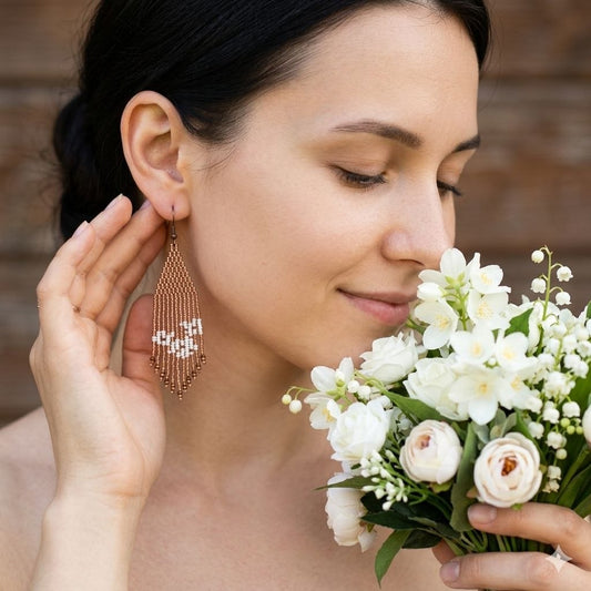 Full view of the earrings showcasing their elegant fringe shape.