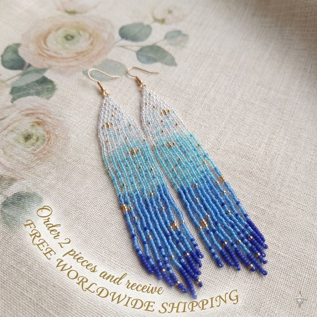 Long seed bead earrings with white and blue color transition and gold accents